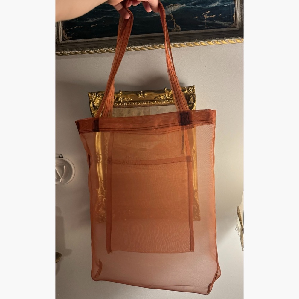 Sheer tote bag in rust orange organza to showoff items you’re carrying
